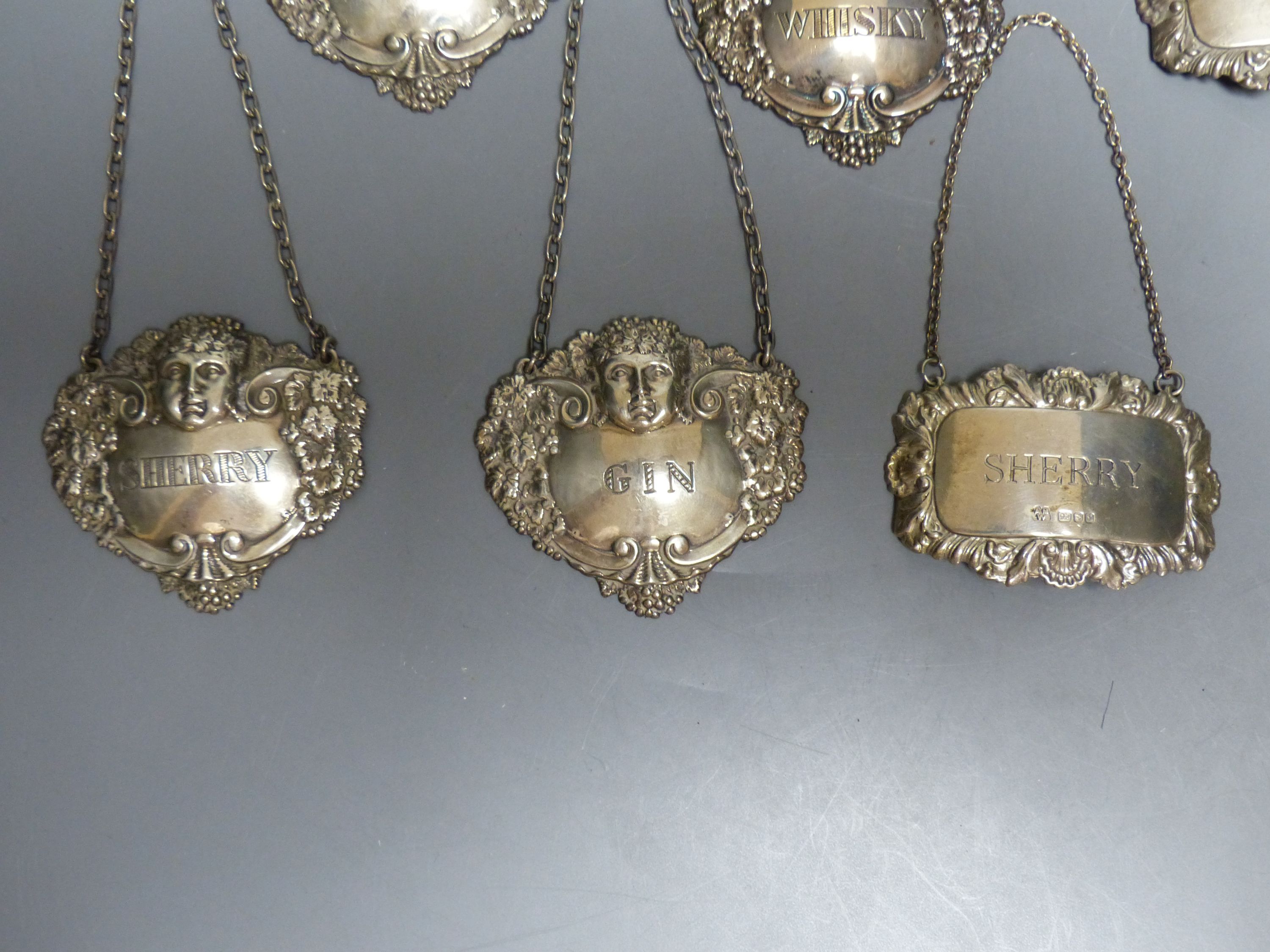 Six assorted modern silver decanter labels, gross 98 grams,